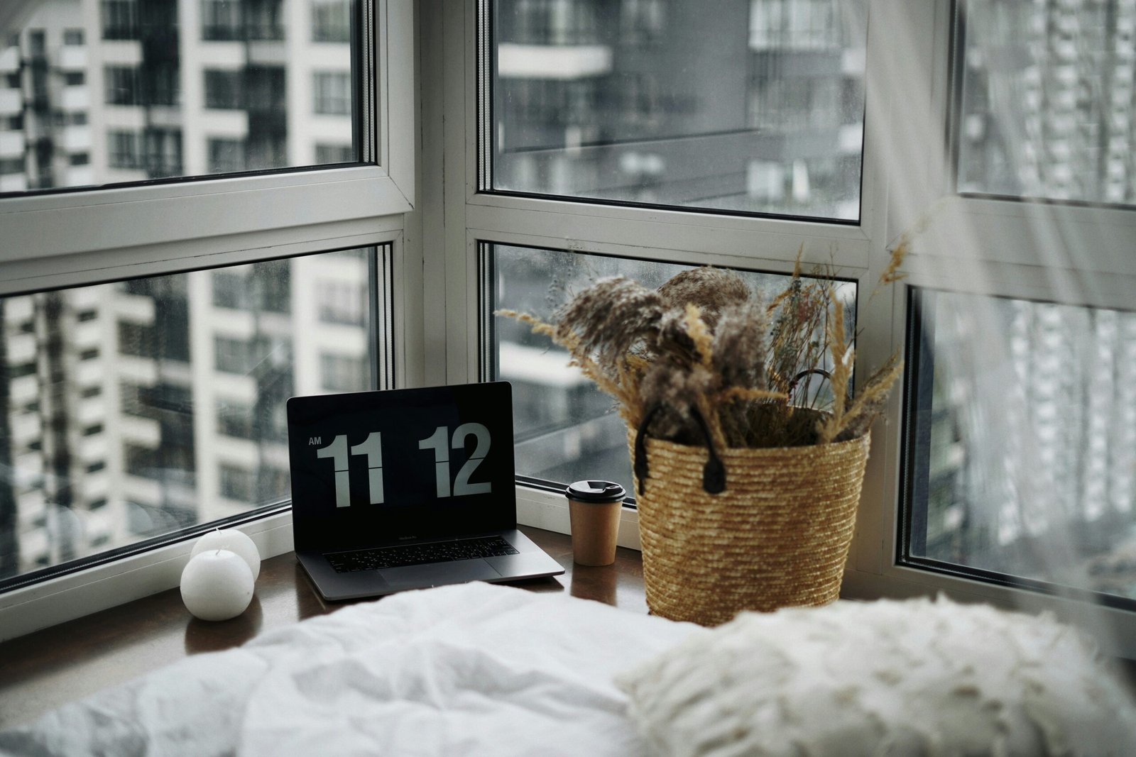A family gathered in their living room, interacting with a smart clock displaying a calendar view.
